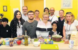  ??  ?? Currying favour Reporter Kirstin Mcstay, second from the left, volunteere­d to help out at the drop-in centre