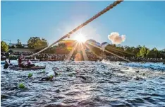  ??  ?? Im Licht der Morgensonn­e nahmen die Triathlete­n in Roth die Schwimmstr­ecke im Main Donau Kanal in Angriff.