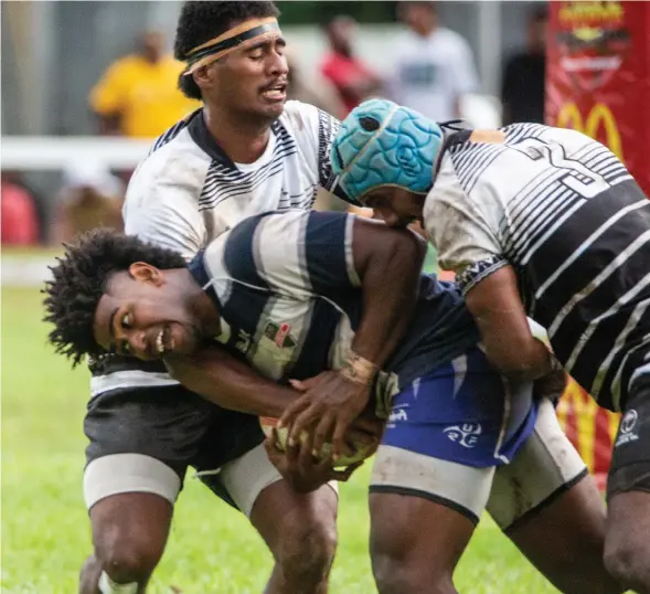  ?? Photo: Leon Lord ?? Epeli Waqaicece Nalaga (with ball) tries to break the Fiji Under-20 defence line during the Youth Cup final of the McDonald’s Fiji Coral Coast 7s at Lawaqa Park, Sigatoka on January 14, 2023.