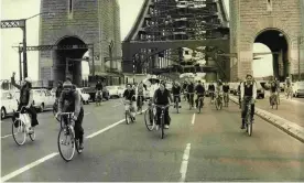  ?? Photograph: Fairfax Media/Getty Images ?? Cyclists ride across Sydney’s Harbour Bridge, holding up car traffic, in 1974. Almost half a century later, cyclists are still not adequately accommodat­ed on the bridge.