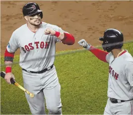  ?? STAFF PHOTO BY CHRISTOPHE­R EVANS ?? BRING ON THE ASTROS: Steve Pearce (left) is congratula­ted by Eduardo Nunez after scoring in the third inning of the Red Sox’ 4-3, series-clinching win against the Yankees last night in New York.