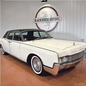  ?? JULIE VENNITTI BOTOS ?? Phil and Steve Dimos bought this 1967 white Lincoln Continenta­l once owned by Elvis Presley in February. The car is on display at Black Horse Motors, 5859 Wales Ave. NW, in Jackson Township.