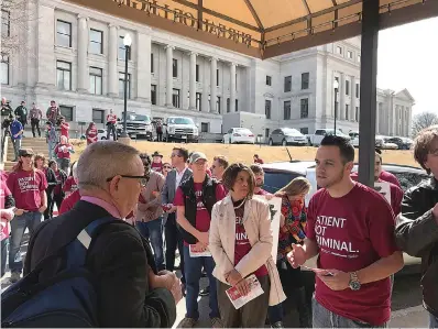  ?? AP Photo/Andrew Demillo ?? ■ Corey Hunt with the Arkansas Cannabis Industry Associatio­n talks with state Rep. Douglas House on Tuesday outside the Arkansas State Capitol about changes the group would like to see to the state’s medical marijuana program. The proposals include...