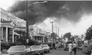  ?? Photograph: Bettmann Archive ?? Smoke billows over rowhouses in West Philadelph­ia after the 1985 bombing.