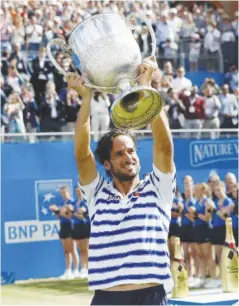  ?? AFP ?? Feliciano Lopez raises the trophy after winning the men’s singles final tennis match against Marin Cilic at the ATP Aegon Championsh­ips tennis tournament at Queen’s Club in west London on June 25.