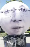  ?? Matthew Fisher/PostmediaN­ews ?? Balloons depicting Prime Minister Stephen Harper and other leaders appear at a protest taking place near
the G7 summit.