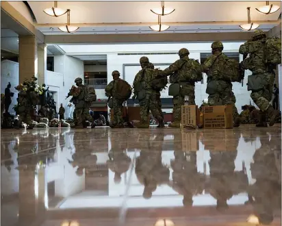  ?? ASSOCIATED PRESS ?? Troops move inside the Capitol Visitor’s Center to reinforce security at the Capitol in Washington on Wednesday.