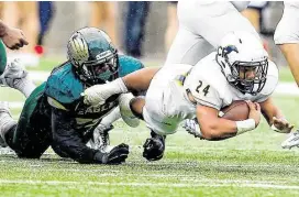  ?? Diana L. Porter / For the Chronicle ?? Cy Ranch’s Ty Laurent leaps for extra yardage in a win over Cy Falls at the Berry Center last weekend.