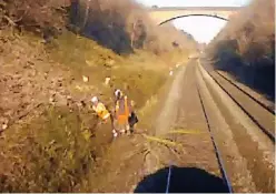  ?? Image: CrossCount­ry/ RAIB ?? Still image taken from the train’s forwardfac­ing CCTV showing the position of the track workers and the tree foul of the line shortly before the train struck the tree