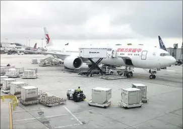  ?? Daniel Slim AFP via Getty Images ?? A CABIN attendant said she was given no gloves or mask before being told to help clean the interior of a plane that arrived at Los Angeles Internatio­nal Airport from China. Above, a China Eastern plane at LAX in 2018.