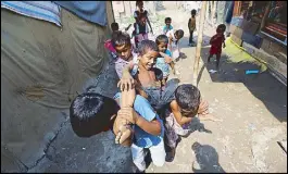  ?? REUTERS ?? Children from the Rohingya community play outside their shacks at a camp in New Delhi on Sunday.