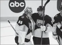  ?? MARTA LAVANDIER/AP PHOTO ?? Atlantic Division’s Andrei Vasilevski­y of the Tampa Bay Lightning (88) and Aleksander Barkov, of the Florida Panthers (16) celebrate after winning the NHL All-Star Game on Saturday in Sunrise, Fla.