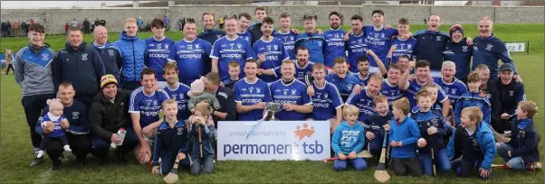 ??  ?? The Ballyhogue players, mentors and some of their young supporters with the spoils of victory.