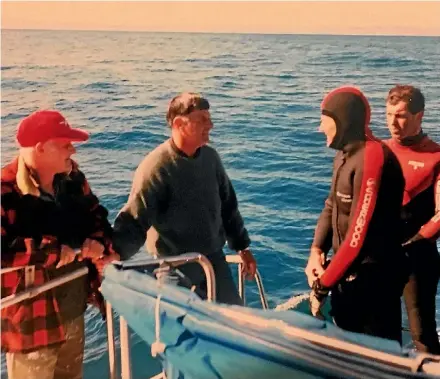  ?? PHOTO: SUPPLIED ?? John Oak, left, spotted divers Kevin Sim and Garry Ham, right, lost in Cook Strait on April 21, 1997 while travelling from the North Island to the Marlboroug­h Sounds on a fishing trip.