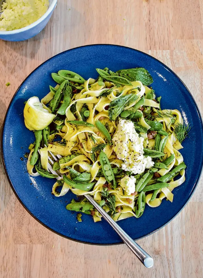  ?? Christian Reynoso/Special to the Chronicle ?? Full of snap peas and green garlic, this spring pasta is finished with a dollop of lemony ricotta.