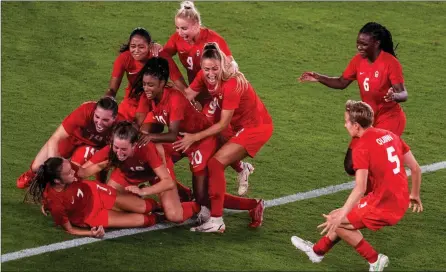  ?? The Associated Press ?? Teammates celebrate with Canada’s Julia Grosso after she scored the winning goal against Sweden at the Olympics, Friday, in Yokohama.