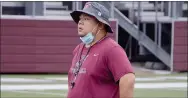  ?? Graham Thomas/Herald-Leader ?? Siloam Springs assistant coach Ehldane Labitad looks on from afar during a break in football practice on Thursday.