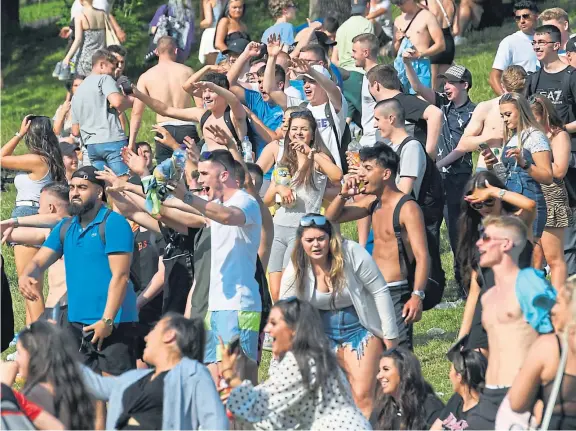  ?? Picture: SNS. ?? Large groups of people ignored social distancing guidelines at Kelvingrov­e Park in Glasgow during the recent fine weather.
