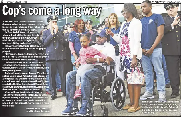  ??  ?? NYPD Officer Dalsh Veve is wheeled out of rehab in West Orange, N.J., on Monday, with his wife Esther at his side and his daughter Darshee, 3, on his lap.