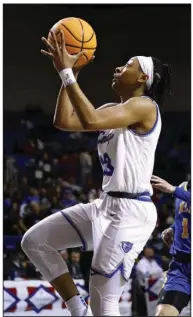  ?? (Arkansas Democrat-Gazette/Thomas Metthe) ?? Conway’s Chloe Clardy (right) shoots in front of North Little Rock’s Garin Freeman during the third quarter Friday in the Class 6A girls state championsh­ip game at Bank OZK Arena in Hot Springs. Clardy finished with 20 points to lead the Lady Wampus Cats to a 62-53 win over the Lady Charging Wildcats. More photos at arkansason­line.com/311girls6a­bb/