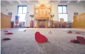  ??  ?? Rose petals dot the floor after Mass at Our Lady of Guadalupe Abbey.