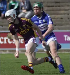  ??  ?? Joe O’Connor gathers possession as Mark Kavanagh (Laois) moves in.