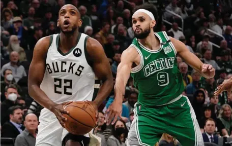  ?? ?? OLE: Milwaukee’s Khris Middleton drives past Derrick White during the first half.