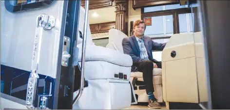  ?? CP PHOTO ?? Bucars RV Centre general manager Jeff Redmond sits in the driver’s seat of one of the company’s recreation­al vehicles worth more than $600,000 in Balzac, Alta., on Oct. 1.