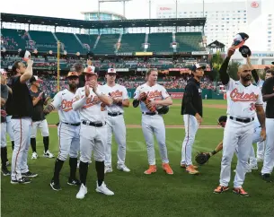  ?? ROB CARR/GETTY ?? The Orioles wave to the crowd in Baltimore after their final regular-season game against Boston.