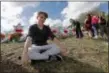  ?? GERALD HERBERT - THE AP ?? In this Feb. 19 file photo, Chris Grady, a student at Marjory Stoneman Douglas High School, sits at a memorial in Parkland, Fla., for those slain in the Feb. 14 school shooting. Grady who had planned to join the U.S. Army before the shooting, has...