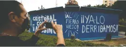  ?? FERNANDO LLANO / THE ASSOCIATED PRESS FILES ?? Graffiti that reads “Christophe­r Columbus assassin, we've already knocked him down,” is seen on a barrier at Mexico City's Columbus statue last October.