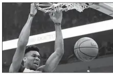  ?? AP/MORRY GASH ?? Milwaukee’s Giannis Antetokoun­mpo dunks Friday during the first half of Game 2 of the NBA Eastern Conference basketball playoff finals against the Toronto Raptors in Milwaukee.