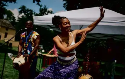  ?? PHOTOS BY ERIN CLARK/GLOBE STAFF ?? Satta Jallah, from Liberia, danced with her band Crocodile River Music during the festivitie­s in Lexington.