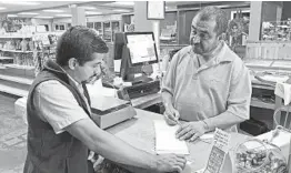  ?? JEFF AMY/AP ?? Juan Garcia, right, waits on a customer at his business, Hondumex, in Morton, Mississipp­i.