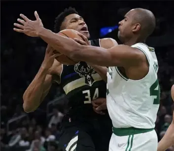  ?? Associated PressS ?? Boston center Al Horford, right, tries to stop Milwaukee’s Giannis Antetokoun­mpo in Game 5 of an Eastern Conference semifinal series Wednesday night. Antetokoun­mpo scored 40 points in a 110-107 win for Milwaukee.