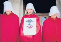  ?? MELANIE STENGEL/SPECIAL TO THE COURANT ?? Maggie Quinn, Susan DeSilver and Katherine Hinds, of the Connecticu­t Handmaid’s Coalition, stand on the steps of the Capitol in Hartford during the Women’s Equality Day rally Sunday.