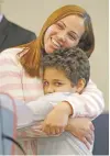  ?? ASSOCIATED PRESS ?? Lidia Karine Souza hugs her son Diogo shortly after they were reunited Thursday in Chicago.