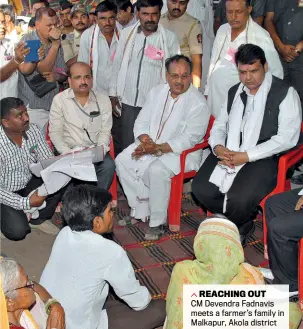  ??  ?? REACHING OUT
CM Devendra Fadnavis meets a farmer’s family in Malkapur, Akola district