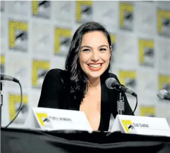  ?? CHARLEY GALLAY/GETTY ?? Gal Gadot takes part in a panel during San Diego Comic-Con 2016 at San Diego Convention Center in San Diego, Calif. She says it was important to portray Wonder Woman in a way everyone can relate to.