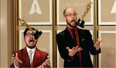  ?? ?? JUGGLING OSCARS Directors Daniel Kwan and Daniel Scheinert, known in Hollywood as “the Daniels”, play the fool with their Oscars this week at the 95th Academy Awards. Their movie ‘Everything Everywhere All at Once’ won seven awards: best picture, best director, original screenplay, film editing, best actress, best actor and best supporting actress