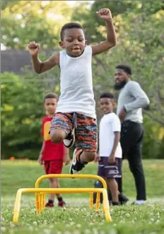  ?? Emily Matthews/Post-Gazette ?? Jayden Taylor, 6, jumps over hurdles during a football training session Monday at Westinghou­se Park in Point Breeze.