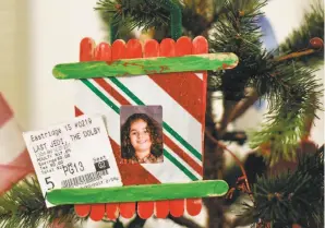  ??  ?? A picture of 6-year-old Orion Juarez hangs from the Christmas tree next to a ticket stub for “Star Wars: The Last Jedi” in the family’s new studio apartment in San Jose.