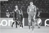  ?? FRANCK FIFE AFP VIA GETTY IMAGES ?? Paris Saint-Germain players celebrate as a Bayern Munich player walks off after their quarterfin­al.