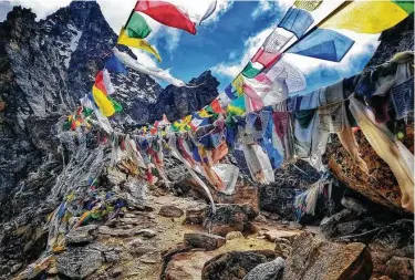  ?? Photos by Tarcy Connors / TNS ?? Prayer flags are strung across the summit of Renjo La Pass in the Himalayas.