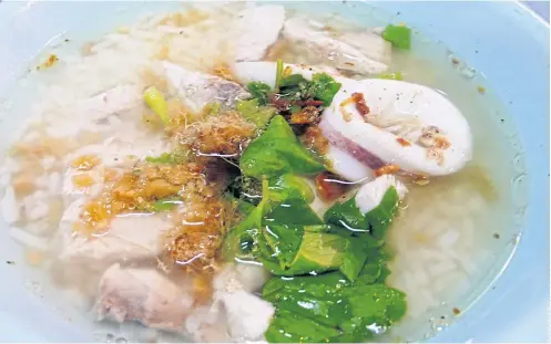  ??  ?? COMFORT FOOD: Soft boiled rice porridge with fish and squid, below.