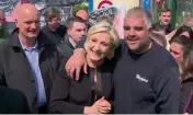  ??  ?? Far-right French presidenti­al candidate Marine Le Pen is greeted by workers outside a Whirlpool home appliance factory in Amiens, France, on Wednesday — AFP