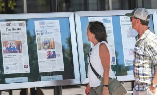  ?? AP PHOTOS ?? People read newspaper front pages from around the United States at the Newseum in Washington, D.C., on Sept. 25. Dorothy Tucker, president of the National Associatio­n of Black Journalist­s, writes that true diversity in a newsroom requires diversity among the top managers.