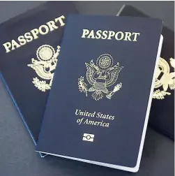 ?? AP ?? In this May 9, 2017 photo, US passports lie on a table in Dallas, Texas. The US State Department is in the middle of a record year for processing passport applicatio­ns, with 20.5 million renewals and applicatio­ns for new passports expected. Adult US...