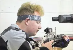  ?? Scott herpst ?? Elijah Webb’s checks his sights while warming up before last week’s rifle match. The Lafayette sharpshoot­er had a 279 in the match against Etowah, including a perfect score of 100 in the opening round.