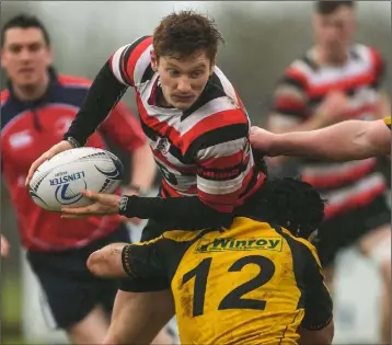  ??  ?? Daniel Pim of Enniscorth­y is tackled by Ashbourne’s MarkRooney.